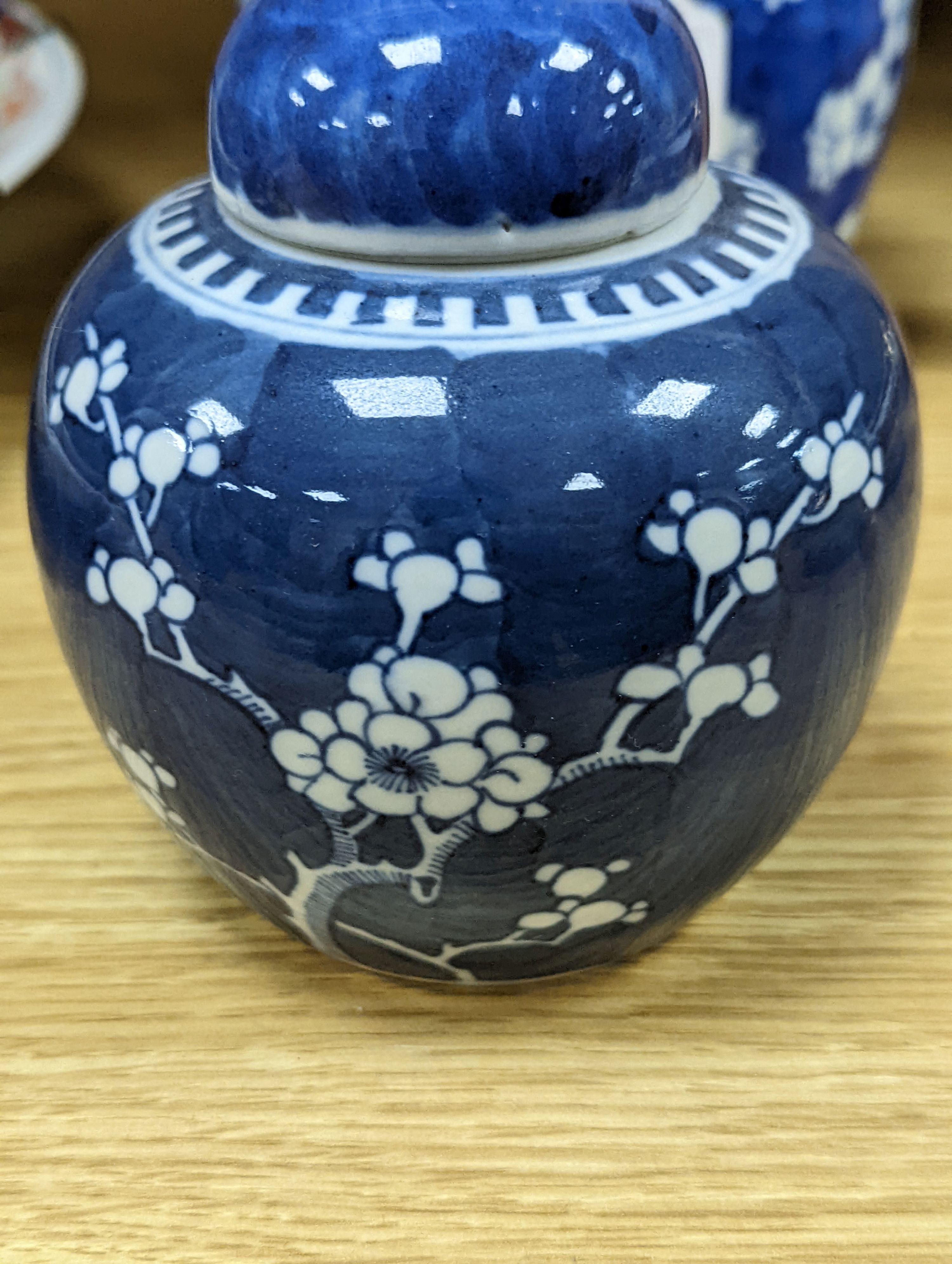 Three Chinese blue and white prunus decorated jars and covers, 19th/20th century, with four character marks 18cm